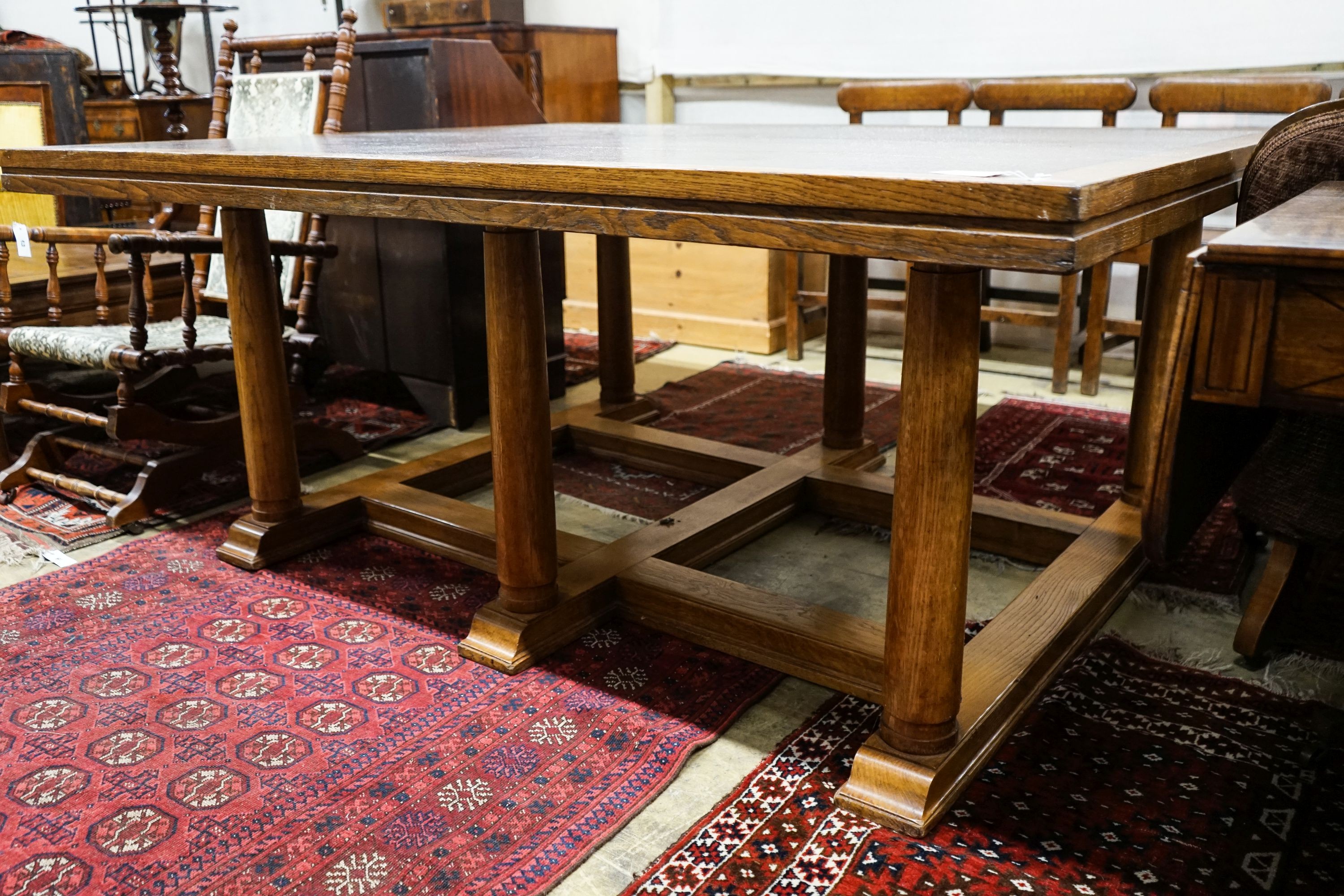 A large rectangular oak dining or boardroom table on six column supports (From The Wills Cigarette Factory, Newcastle), length 182cm, depth 152cm, height 77cm